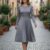 Vestido gris a media pantorrilla ruedo completo
