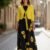 Vestido negro y amarillo flores medio ruedo largo